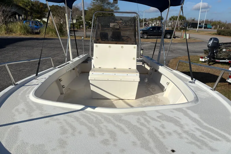 Slide: The Image of 1992 Parker 18 boat with center console and canopy, parked outdoors. - 16