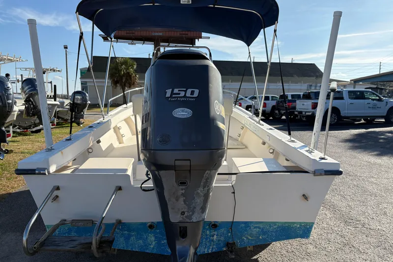 Slide: The Image of 1992 Parker 18 boat with Yamaha 150 engine, parked outdoors under blue sky. - 3
