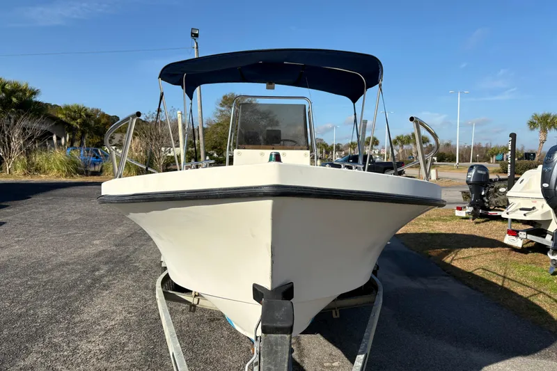 Slide: The Image of 1992 Parker 18 boat on trailer, sunny day, outdoor setting. - 7