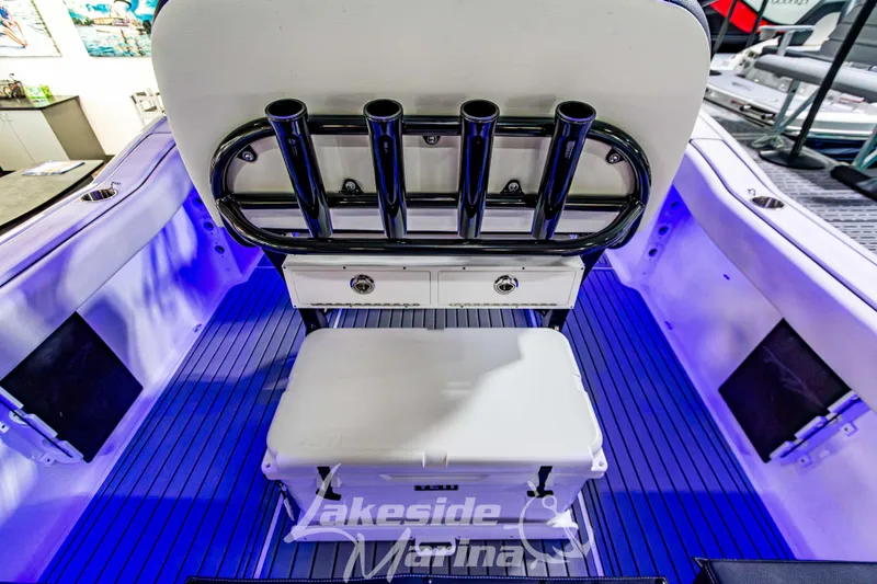 Slide: The Image of 2026 Tidewater 232 LXF boat interior with rod holders and Yeti cooler, Lakeside Marina. - 14