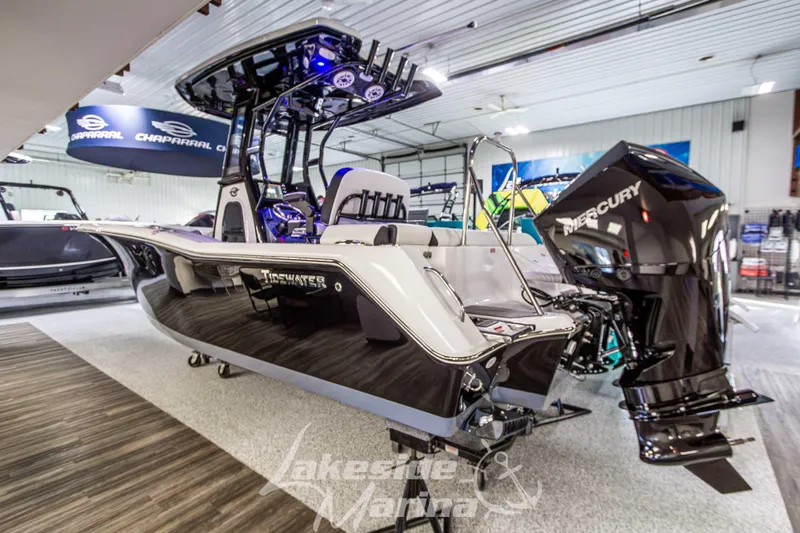 Slide: The Image of 2026 Tidewater 232 LXF boat displayed indoors at Lakeside Marina. - 2