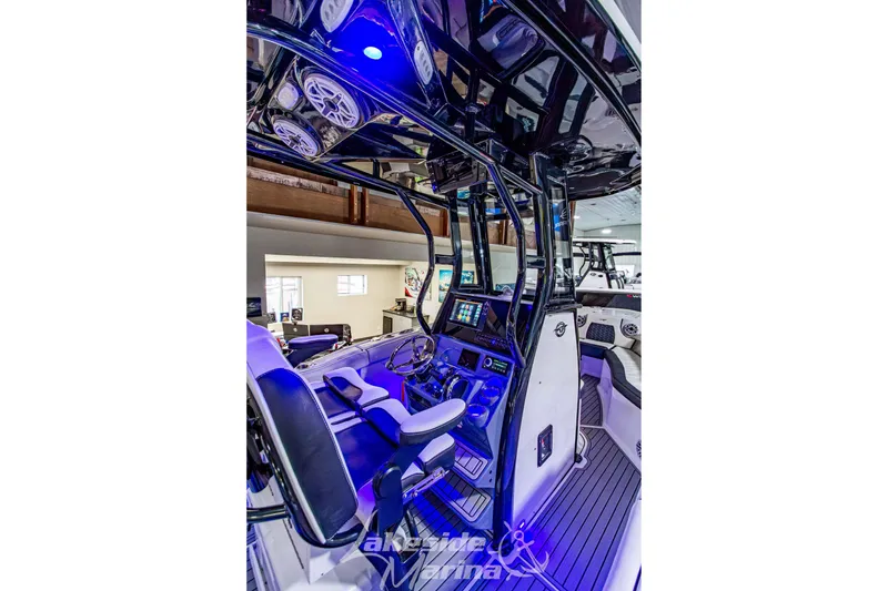 Slide: The Image of 2026 Tidewater 232 LXF boat with sleek design and advanced audio system. - 21