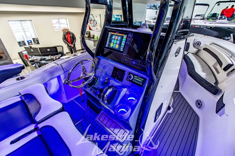 Slide: The Image of 2026 Tidewater 232 LXF boat interior with modern dashboard and seating at Lakeside Marina. - 25