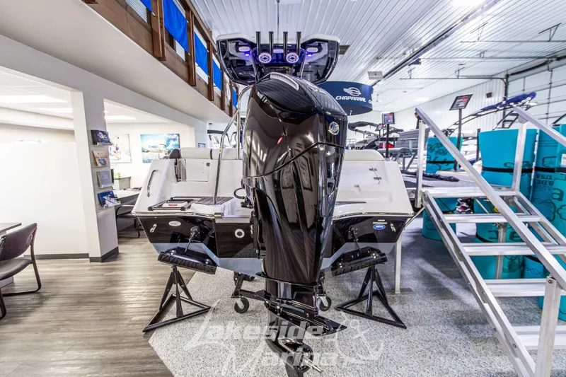 Slide: The Image of 2026 Tidewater 232 LXF boat with Mercury engine displayed indoors. - 3