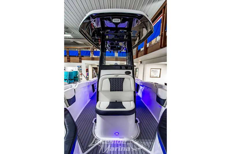 Slide: The Image of 2026 Tidewater 232 LXF boat interior with modern seating and ambient lighting in showroom. - 38