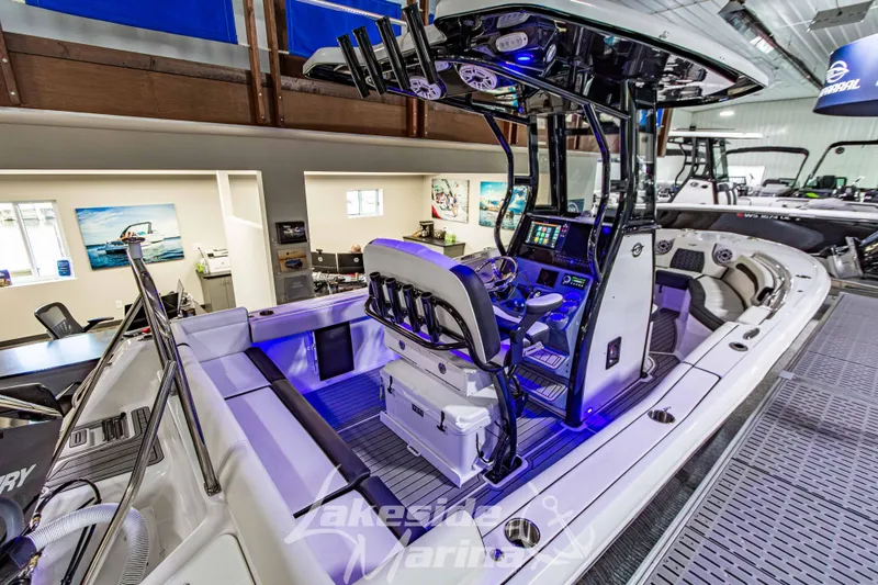 Slide: The Image of 2026 Tidewater 232 LXF boat displayed in a showroom with modern interior. - 4