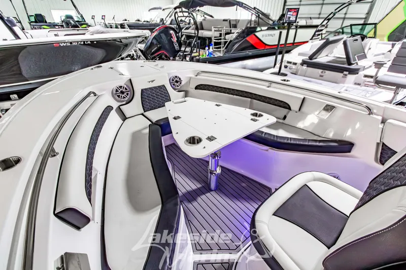 Slide: The Image of 2026 Tidewater 232 LXF boat interior with seating and table, showcasing modern design. - 47