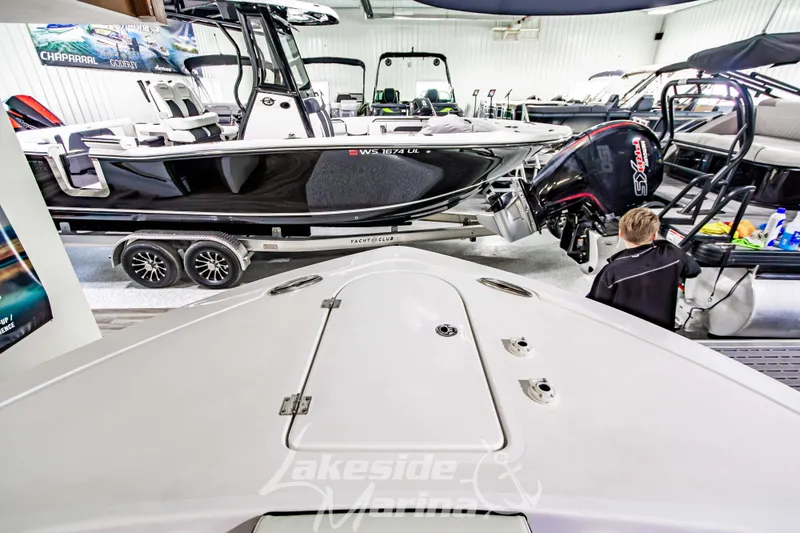 Slide: The Image of 2026 Tidewater 232 LXF boat interior with cushioned seating and speakers. - 49