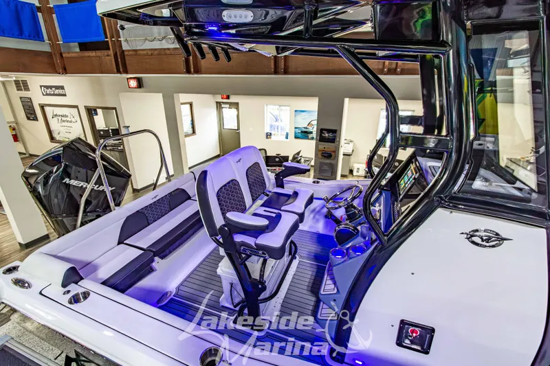 Slide: The Image of 2026 Tidewater 232 LXF boat interior with modern console and seating, displayed at Lakeside Marina. - 5