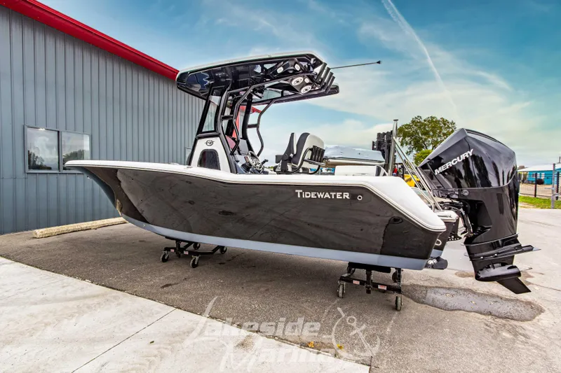 Slide: The Image of 2026 Tidewater 232 LXF boat displayed outdoors, featuring sleek black design and modern features. - 52