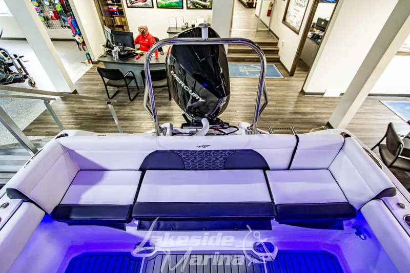 Slide: The Image of 2026 Tidewater 232 LXF boat displayed indoors at Lakeside Marina. - 7