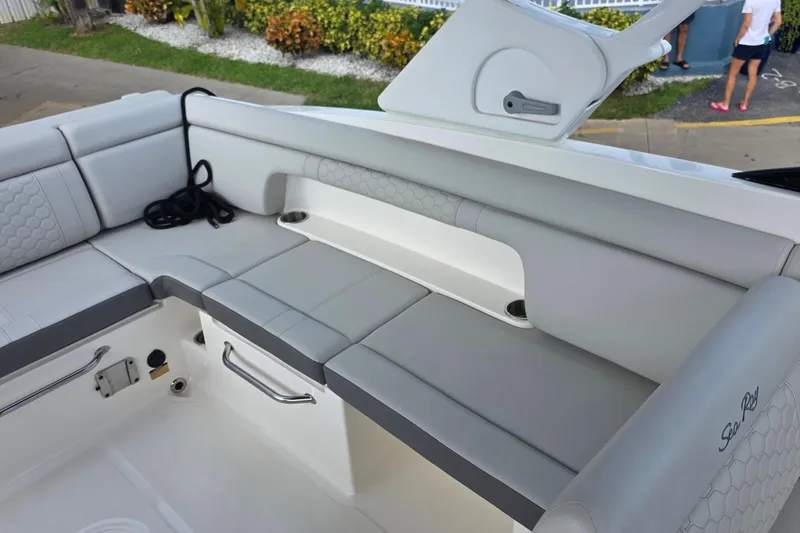 Slide: The Image of 2021 Sea Ray SDX 290 Outboard boat interior with gray seating and storage compartments. - 10