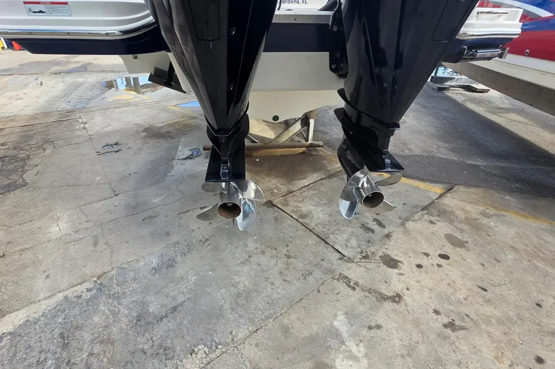 Slide: The Image of 2021 Sea Ray SDX 290 Outboard boat with dual propellers on a concrete surface. - 12