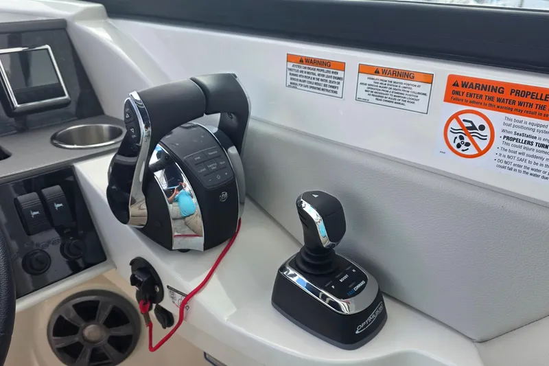 Slide: The Image of Control panel of 2021 Sea Ray SDX 290 Outboard with joystick and throttle controls. - 13