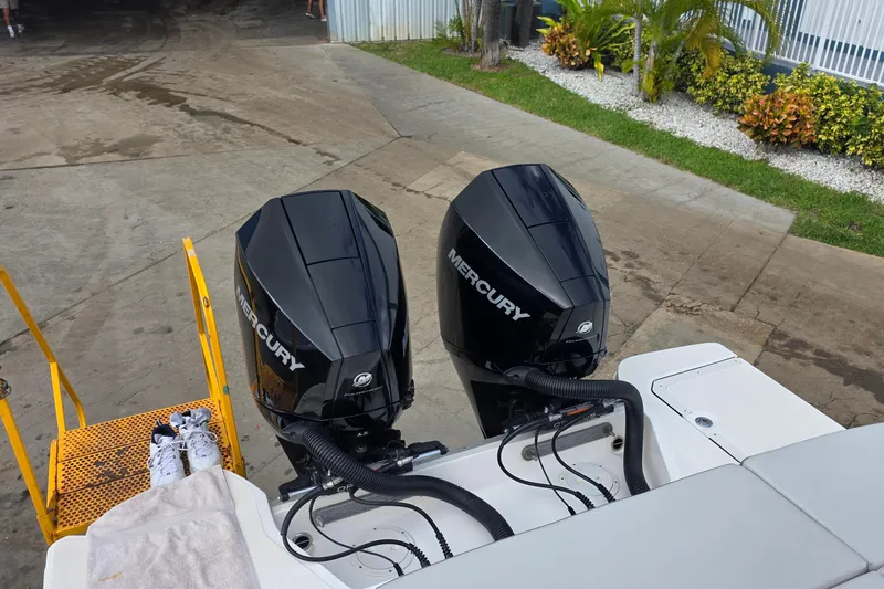 Slide: The Image of 2021 Sea Ray SDX 290 Outboard with dual Mercury engines, docked near greenery. - 16