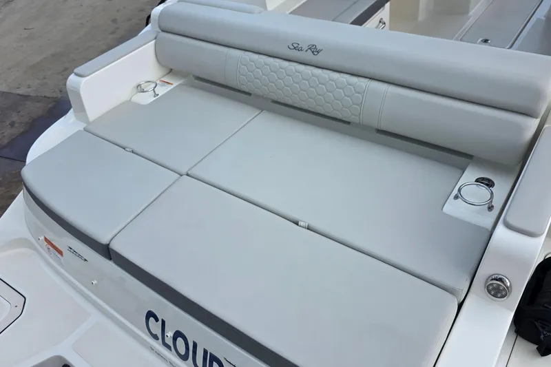 Slide: The Image of 2021 Sea Ray SDX 290 Outboard boat with cushioned seating and cup holders. - 19