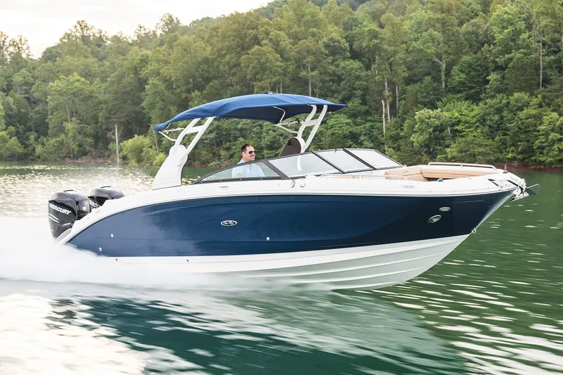 Slide: The Image of Manufacturer Provided Image: 2021 Sea Ray SDX 290 Outboard cruising on a lake with lush green forest background. - 2