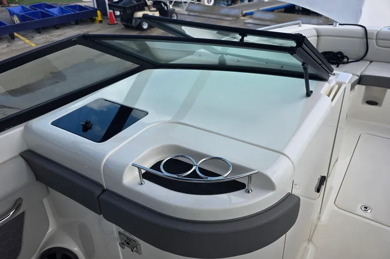 Slide: The Image of 2021 Sea Ray SDX 290 Outboard boat interior with windshield and cup holders. - 26