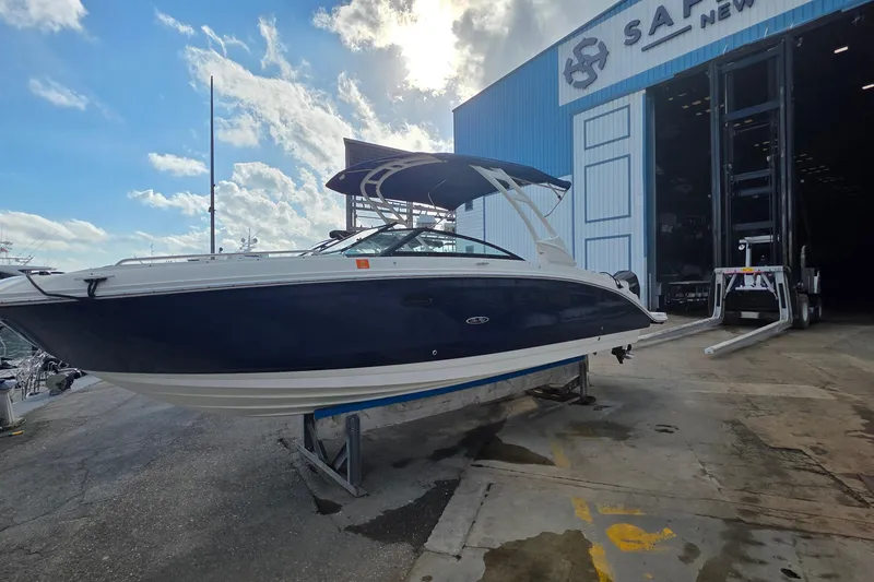 Slide: The Image of 2021 Sea Ray SDX 290 Outboard boat on a dock, under a partly cloudy sky. - 30