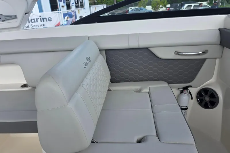 Slide: The Image of 2021 Sea Ray SDX 290 Outboard interior with gray seating and safety equipment. - 31