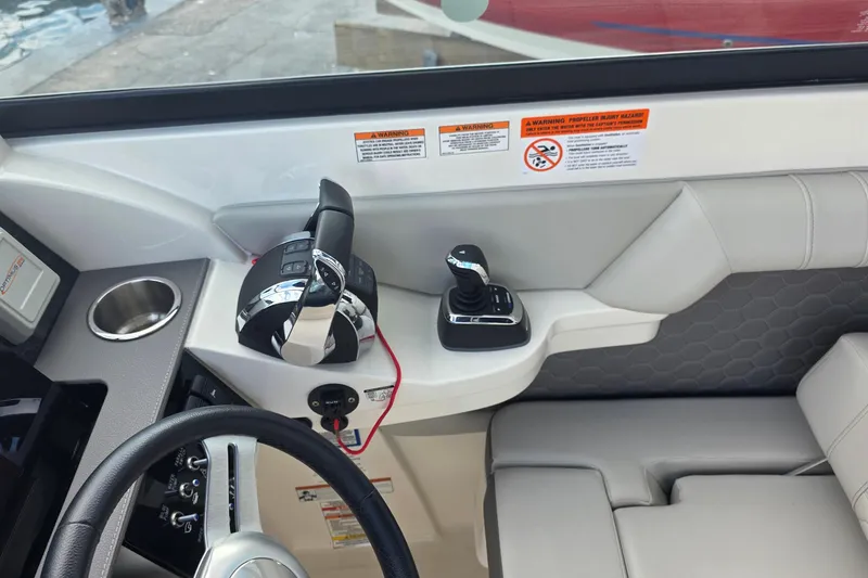 Slide: The Image of 2021 Sea Ray SDX 290 Outboard helm with controls and cup holder. - 4
