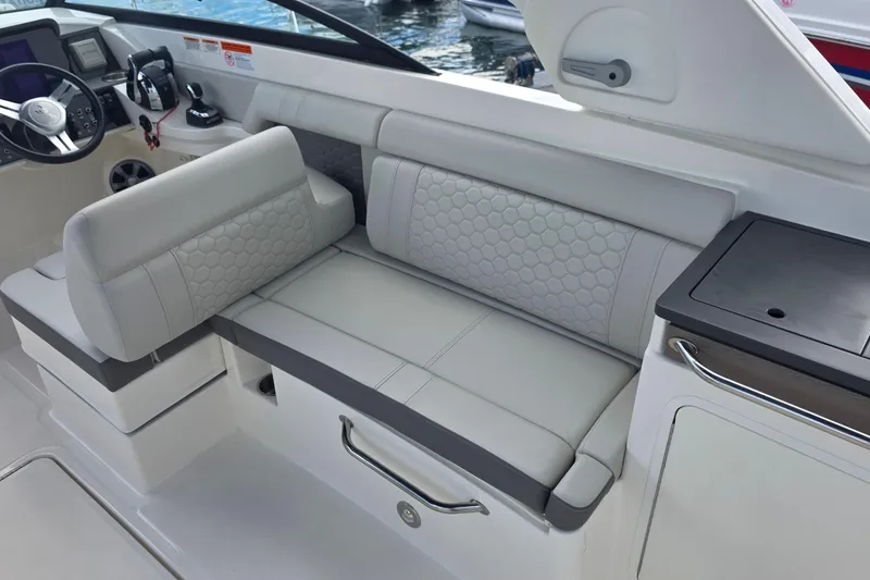 Slide: The Image of 2021 Sea Ray SDX 290 Outboard interior with luxurious seating and modern dashboard. - 6