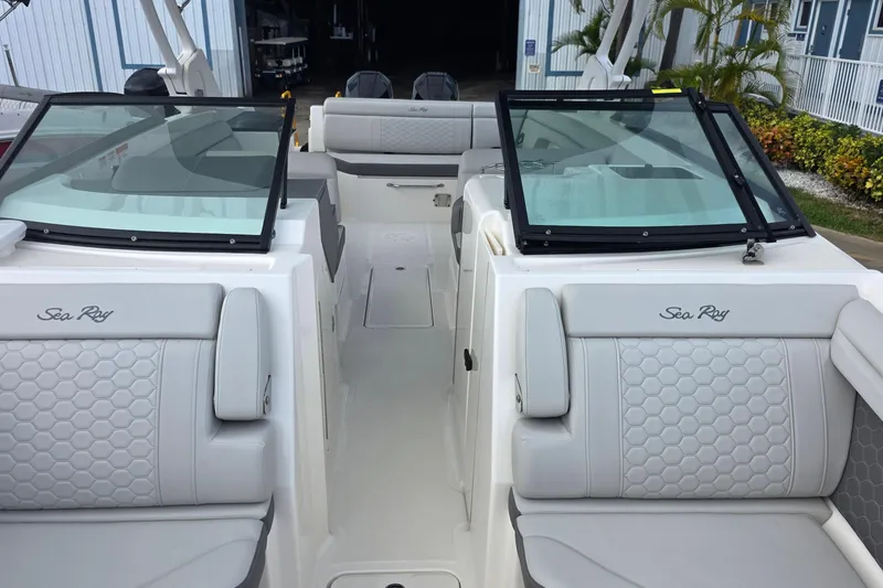Slide: The Image of 2021 Sea Ray SDX 290 Outboard boat interior with luxurious seating and windshield. - 8