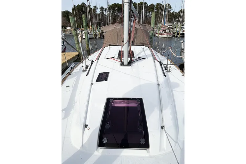 Slide: The Image of 2013 Jeanneau Sun Odyssey 409 sailboat deck with marina background. - 10