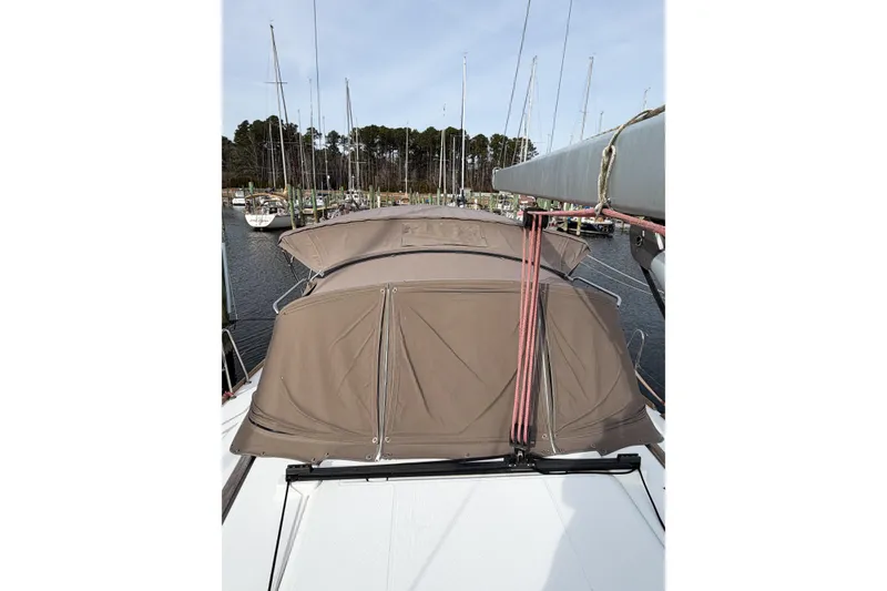 Slide: The Image of 2013 Jeanneau Sun Odyssey 409 sailboat docked at marina, featuring covered cockpit. - 12