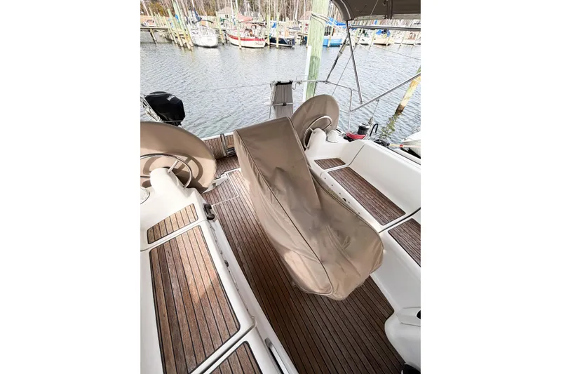 Slide: The Image of 2013 Jeanneau Sun Odyssey 409 cockpit with covered helm, docked at marina. - 15