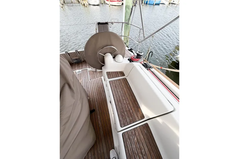 Slide: The Image of 2013 Jeanneau Sun Odyssey 409 cockpit with wooden flooring and steering wheel. - 17
