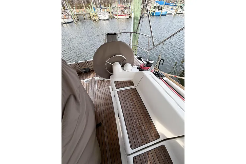 Slide: The Image of Cockpit of 2013 Jeanneau Sun Odyssey 409 sailboat with wooden deck and steering wheel. - 18