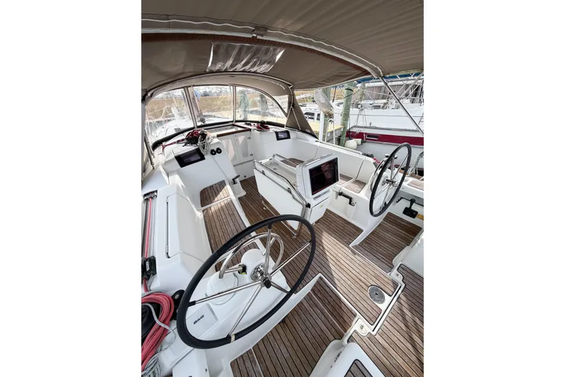 Slide: The Image of 2013 Jeanneau Sun Odyssey 409 yacht cockpit with dual steering wheels and teak flooring. - 22