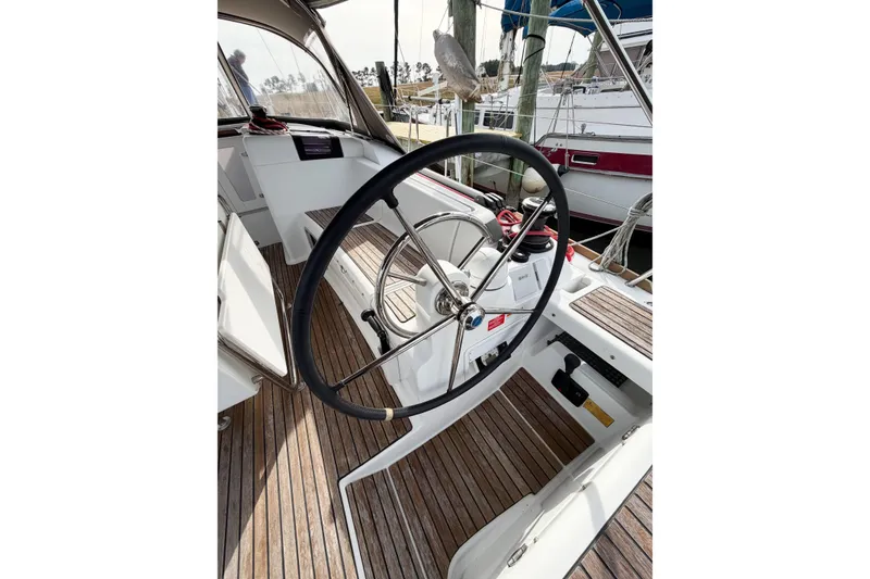 Slide: The Image of Steering wheel of 2013 Jeanneau Sun Odyssey 409 sailboat with wooden deck. - 23