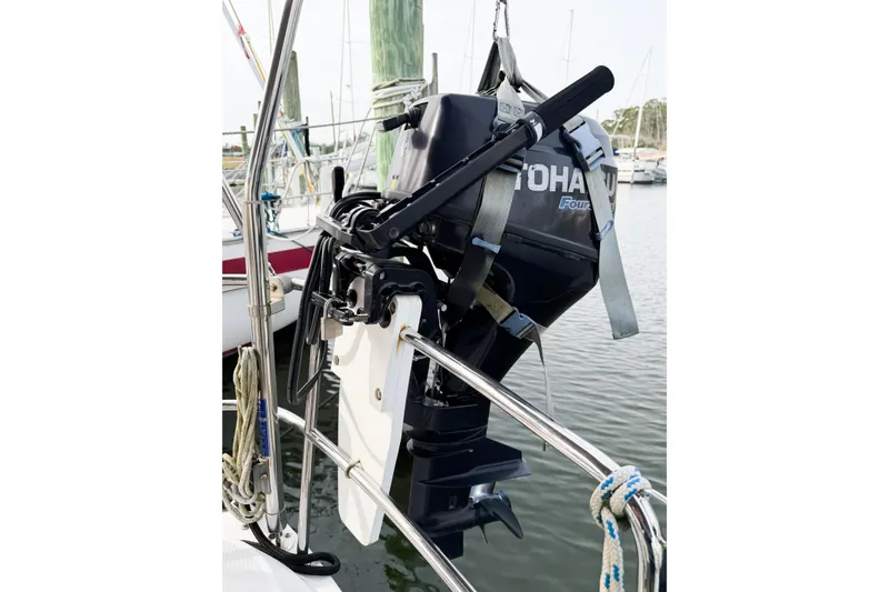 Slide: The Image of Outboard motor mounted on Jeanneau Sun Odyssey 409 sailboat, 2013 model, in marina setting. - 30