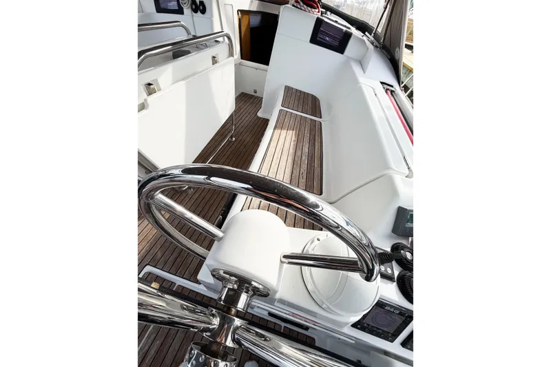 Slide: The Image of Cockpit of 2013 Jeanneau Sun Odyssey 409 sailboat with wooden flooring and steering wheel. - 32