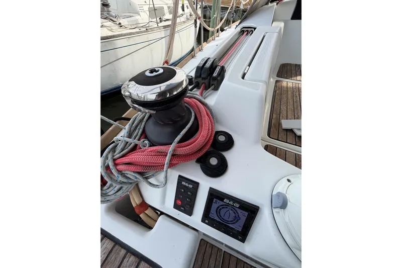 Slide: The Image of Jeanneau Sun Odyssey 409 sailboat deck with winch, ropes, and navigation display, 2013 model. - 33