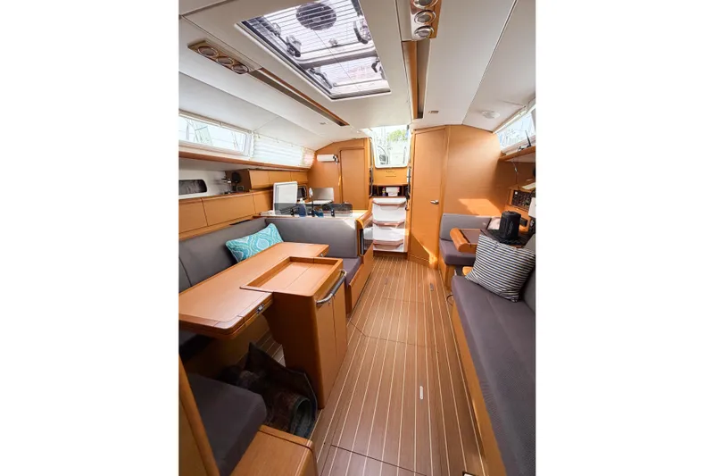 Slide: The Image of Interior of 2013 Jeanneau Sun Odyssey 409 sailboat, featuring modern wood finish and seating. - 36