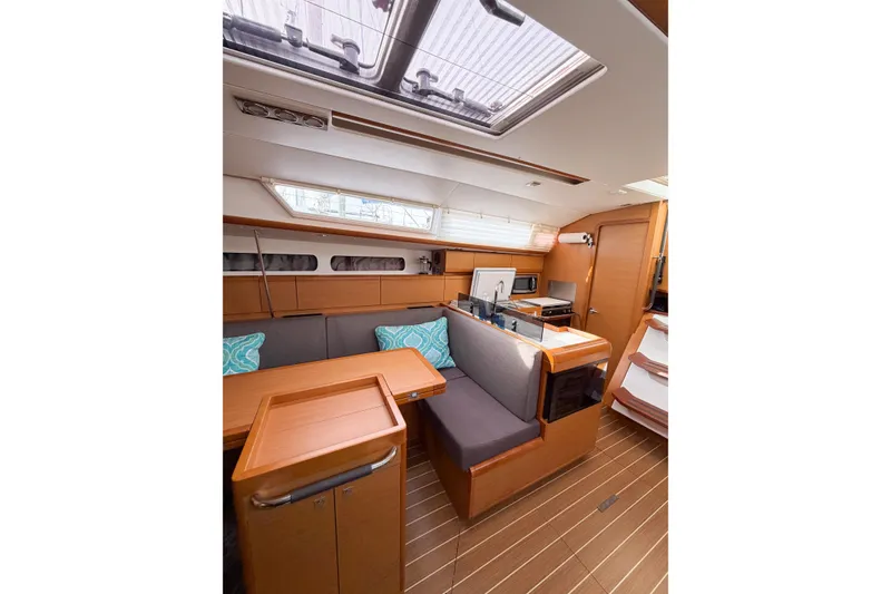 Slide: The Image of Interior of 2013 Jeanneau Sun Odyssey 409 sailboat with modern wood finish and seating area. - 37