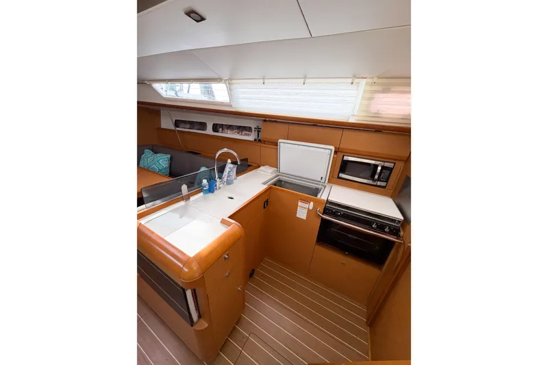 Slide: The Image of Interior of 2013 Jeanneau Sun Odyssey 409 yacht, featuring a modern kitchen galley. - 38