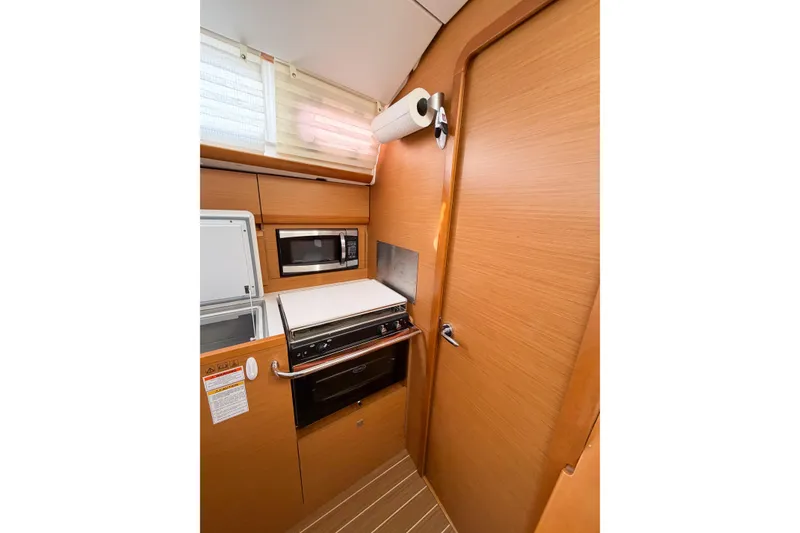 Slide: The Image of Interior of 2013 Jeanneau Sun Odyssey 409 yacht kitchen with wood finish and modern appliances. - 39