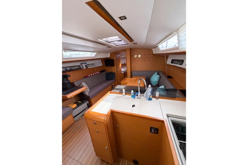 Slide: The Image of Interior of 2013 Jeanneau Sun Odyssey 409 sailboat, featuring modern kitchen and seating area. - 42