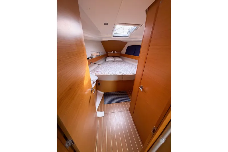 Slide: The Image of Cozy cabin interior of 2013 Jeanneau Sun Odyssey 409 sailboat with wooden finish. - 47