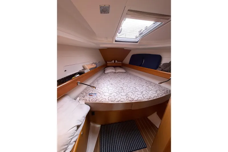 Slide: The Image of Cozy cabin interior of 2013 Jeanneau Sun Odyssey 409 sailboat with skylight and bedding. - 48