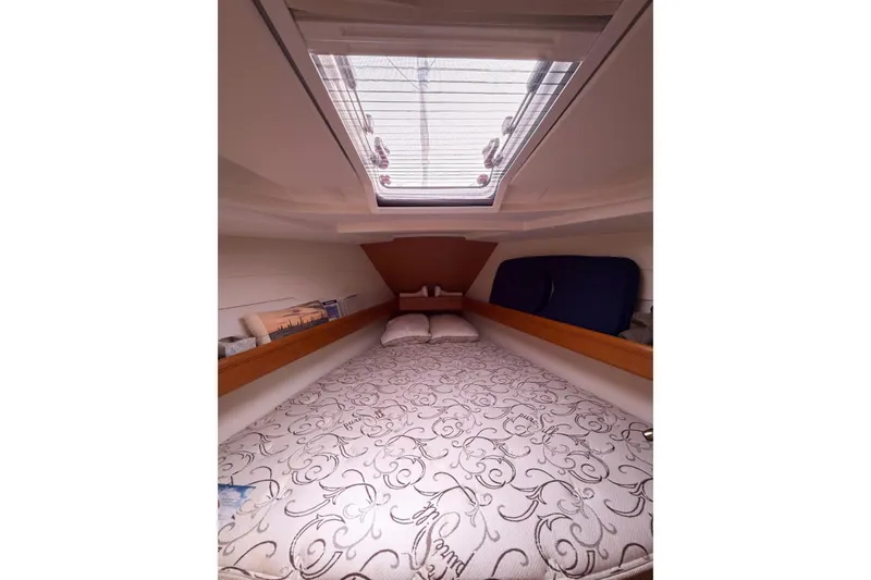 Slide: The Image of Cozy cabin interior of 2013 Jeanneau Sun Odyssey 409 sailboat with skylight and patterned bedding. - 49