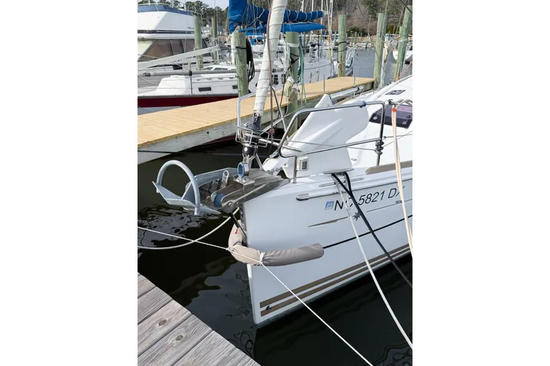 Slide: The Image of 2013 Jeanneau Sun Odyssey 409 sailboat docked at marina, showing anchor and bow details. - 5