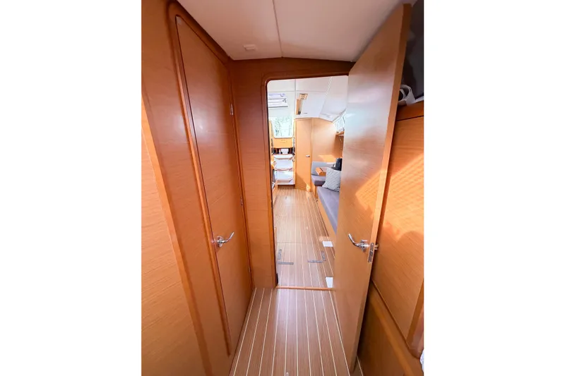 Slide: The Image of Interior view of 2013 Jeanneau Sun Odyssey 409 sailboat, featuring wooden doors and flooring. - 50