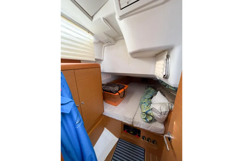 Slide: The Image of Cozy cabin interior of 2013 Jeanneau Sun Odyssey 409 sailboat with bedding and storage. - 53