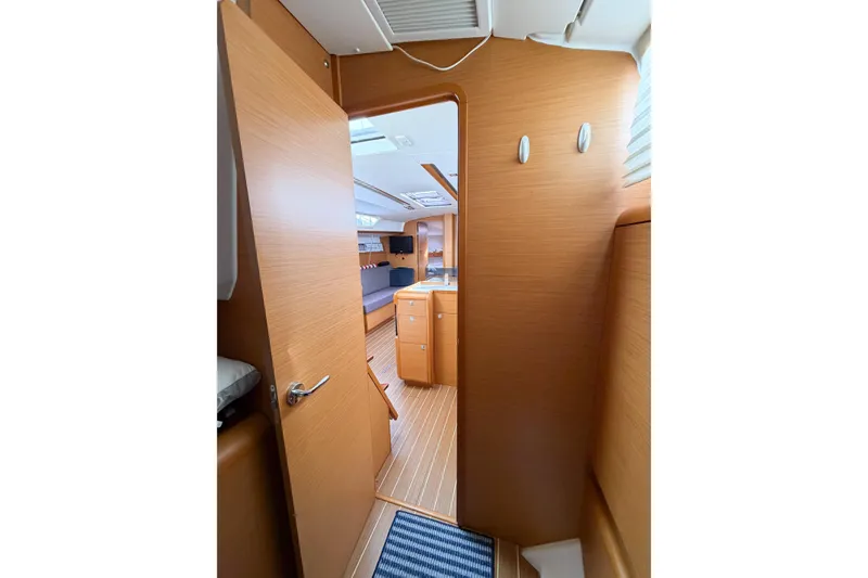 Slide: The Image of Interior view of 2013 Jeanneau Sun Odyssey 409 sailboat, featuring wooden finishes and cozy cabin space. - 54