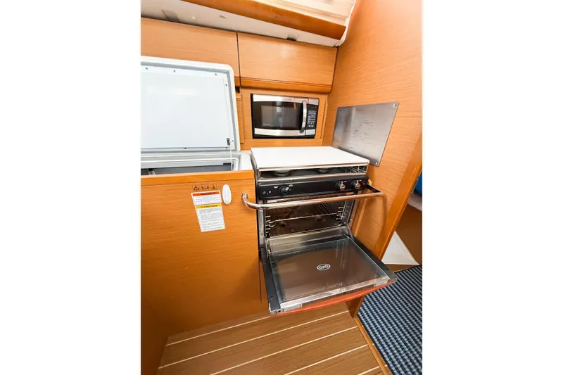 Slide: The Image of Galley kitchen in 2013 Jeanneau Sun Odyssey 409 sailboat with oven and microwave. - 55